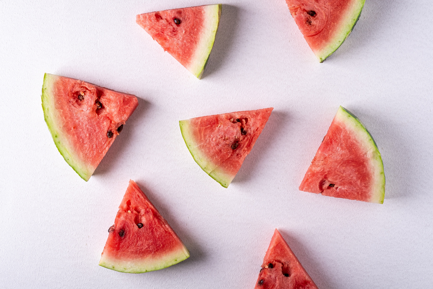 Watermelon slices on white background, pattern, texture, top view, flat lay